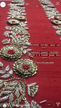 an image of a red table cloth with gold flowers on it and the words, another bridal wear on it