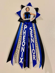 a blue ribbon with an image of a woman on it and the words pheonix