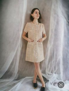 This exquisite dress is a true work of art, handcrafted with meticulous care and attention to detail. Made from a luxurious multi-pink tweed fabric, this versatile piece showcases a delightful blend of pink hues that evoke a sense of femininity and elegance. Adorned with delicate floral pearl buttons, each one a tiny work of art in itself, this dress exudes a touch of sophistication and charm. The pearl buttons add a subtle shimmer and a hint of glamour to the overall design. Designed to be as v Cream Short Sleeve Mini Dress For Work, Spring Tweed Button Dress, Fitted Short Sleeve Tweed Dress, Elegant Beige Mini-length Tweed Dress, Chic Short Sleeve Tweed Dress For Formal Occasions, Elegant Beige Mini Tweed Dress, Fitted Tweed Dress With Buttons And Short Sleeves, Fitted Short Sleeve Tweed Dress With Buttons, Formal Short Sleeve Tweed Dress