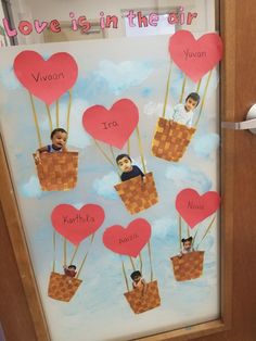 valentine's day bulletin board with hearts in the air and two children on hot air balloons