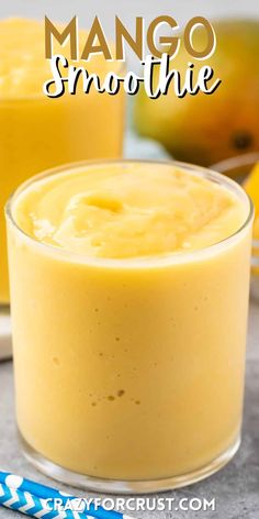 two glasses filled with mango smoothie on top of a table