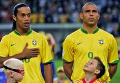 two soccer players standing next to each other