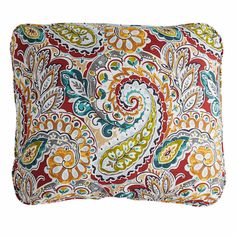 an orange and green pillow with paisley print on the front, sitting on a white background