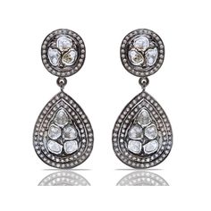 A dazzling melange of Diamonds in contrasting grey and white hues in a contemporary interpretation of classic Jaipur design on the most spectacular chandelier earrings.- Grey Diamonds weight approx 2.80 Carats.- White Diamonds weight approx 1.80 Carats.- Set in Blackened Oxidized Silver. Luxury Teardrop Diamond Earrings With Single Cut Diamonds, Luxury Rose Cut Drop Diamond Earrings, Hand Set Diamond White Teardrop Diamond Earrings, Hand Set Diamond White Teardrop Earrings, Luxury Black Diamond Earrings, Rose Cut Diamond Chandelier Earrings, Hand-set White Diamond Teardrop Earrings, Luxury Silver Chandelier Earrings With Rose Cut Diamonds, Luxury Rose Cut Diamond Drop Earrings