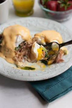 a white plate topped with meat covered in gravy