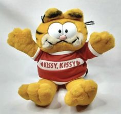 a stuffed animal that is wearing a red shirt with the words pussyy, kissy on it's chest