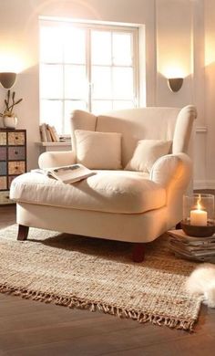 a living room filled with furniture and a cat laying on the floor next to it