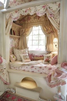 a bedroom with pink flowers on the walls and bed in the window sill,