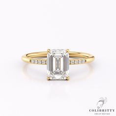 an emerald - cut diamond engagement ring in 18k rose gold, set on a white background