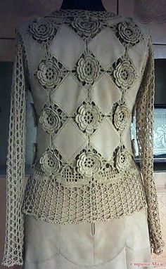 a white jacket with crocheted lace on it