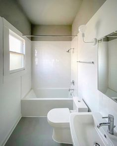 a bathroom with a toilet, sink and bathtub