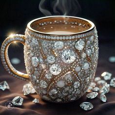 a coffee cup with lots of diamonds on the side and steam rising out of it