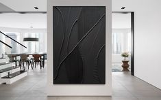 an abstract art piece in the middle of a room with white walls and flooring