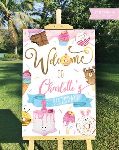 a welcome to charlotte's 1st birthday sign on a easel in the grass