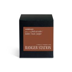 the ranger station soap bar is in a black box with brown labels on it and sits next to a white background