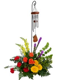 a vase filled with flowers and a wind chime