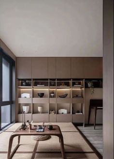 a living room filled with furniture and lots of shelves next to a large window on the wall