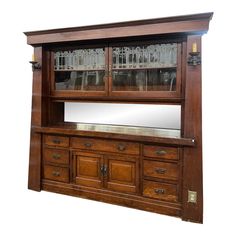 a wooden cabinet with glass doors and drawers