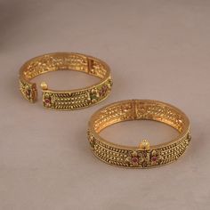 Indian Royal Antique Ruby Gold Plated Brass Bangles   is a timeless piece that will provide you with years of beautiful wear. The metal-brass alloy with gold plating is made to last. Indian Royal Antique Ruby Gold Plated Brass Bangles    is show-stopping and comes in traditional Indian design with gold plating and handwork.   NOTE: This Indian Royal Antique Ruby Gold Plated Brass Bangles    has been crafted by hand and may have slight irregularities or imperfections in color or embellishment. These irregularities are the result of human involvement in the process and add to the finished product's charm while ensuring you have a one-of-a-kind piece. Gold-tone Metal Bangle For Wedding, Formal Gold Brass Bangle, Gold Brass Bangle With Intricate Design, Brass Gold Bracelet For Wedding, Gold Brass Bracelet For Wedding, Ornate Gold Brass Bangle, Antique Gold Metal Bracelets For Wedding, Festive Gold Metal Bangle, Wedding Gold Brass Bracelets