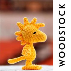 a small crocheted giraffe is posed in front of a white background