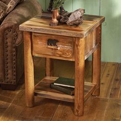 a wooden table sitting on top of a hard wood floor next to a chair and couch