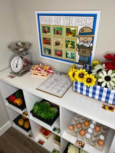 a table topped with lots of different types of vegetables and fruits next to a sign that says food on the farm