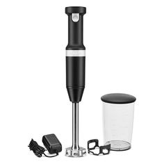 a black and white blender sitting next to an electric device on a white background