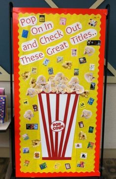 a popcorn machine with the words pop in and check out these great titles on it