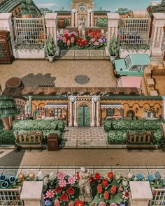 an aerial view of a house with flowers in the front yard