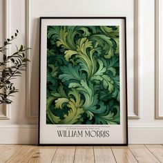 a green and yellow art print with the words william morris on it in front of a white wall