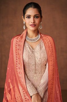 COLOR : Dusty Mauve & Peach FABRIC : Top & Bottom - Pure Georgette, Inner - Silk Santoon, Dupatta - Pure Banarasi Jacquard WORK : Resham & Zari Embroidery, Woven Zari, Stones, Sequins, Motifs, Lace BorderOCCASION : Wedding, Reception, Mehendi, Engagement, Party Wear, Festival READY-TO-WEAR : No STITCHING : Available as semi-stitched fabric, can be stitched using standard size option (+$20). Note: There might be a slight color variation due to lighting and flash used during photoshoot. The bright White Organza Dupatta, Classy Accessories, Kurta Pants, Rose Pink Dress, Georgette Material, Floor Length Anarkali, Designer Gown, Eid Outfits, Dusty Mauve