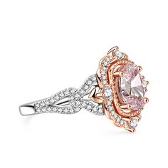 an engagement ring with pink and white diamonds on the band, set in 18k rose gold