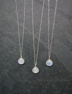 Moonstone gemstone pendant on a Sterling Silver chain. These Moonstone pendants are gorgeous with fire (iridescent flashes of color Moonstone is known for.) Customize your necklace in your preferred chain length. Select from 3 chain designs: cable, link or satellite.White moonstone facilitates spiritual growth. When you move these stones around often you will see beautiful colors reflected back at you, shimmering colors which may include scintillating shades of blue and purple.Your necklace will White Moonstone Jewelry With Moon Charm, White Moonstone Crystal Necklace With Moon Charm, Mystical White Moonstone Necklaces, Mystical White Moonstone Necklace, Minimalist Moonstone Crystal Necklace With Gemstone, Silver Crystal Necklaces With Birthstone, Moonstone, Mystical Moonstone Jewelry With Birthstone, Silver Moonstone Crystal Necklace With Birthstone, Dainty Moonstone Moon Necklaces