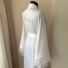 Elegant Party Robe With Feather Trim, Elegant Long Sleeve Robe For Bridal Shower, Elegant Robe With Feather Trim For Wedding Night, Wedding Satin Robe With Feathers, Feathered Robe For Wedding Night, Elegant Wedding Robe With Feathers, Wedding Satin Dress With Feather Trim, Satin Wedding Dress With Feather Trim, Feathered Dresses For Wedding Night