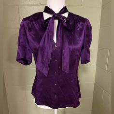 Nwt, Satin Button-Up Blouse With Neck Tie/Bow Detail. Purple In Color. Classic Style. Purple Fitted Button-up Blouse, Purple Short Sleeve Blouse With Buttons, Purple Short Sleeve Button Blouse, Chic Purple Blouse With Button Closure, Fitted Purple Tops For Office Wear, Chic Purple Tops With Buttons, Formal Purple Blouse With Button Closure, Classic Purple Blouse With Button Closure, Chic Purple Buttoned Blouse