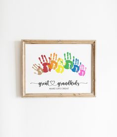 a colorful hand print hangs on the wall next to a framed sign that reads great grandchilds make life great