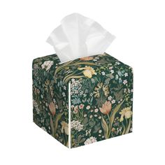 a tissue box with a green floral design on the front and white tissue in the middle