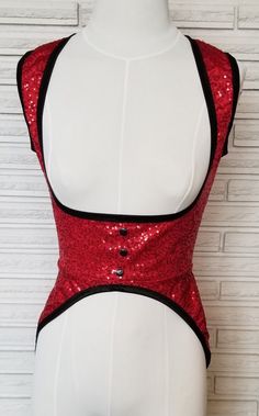 a mannequin with red sequins and black trim on it's chest