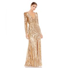 a woman wearing a gold dress with long sleeves and sequins on the side