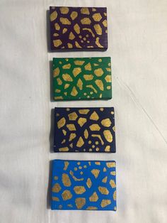 three pieces of painted wood with gold and blue designs on them, each piece has an animal print pattern