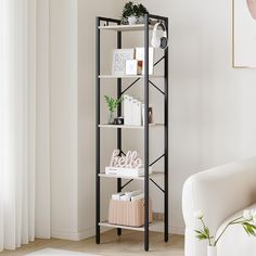 a living room with a white chair and shelving unit