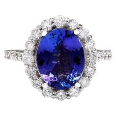 Indulge in elegance with our stunning 4.46 Carat Natural Tanzanite Ring, crafted in luxurious 14K White Gold. The centerpiece is a captivating oval-shaped Tanzanite, weighing 3.66 Carats and measuring 11.00x9.00 mm. Accompanying this mesmerizing gem are sparkling round Diamonds totaling 0.80 Carats, boasting F-G color and VS2-SI1 clarity. With a total metal weight of 4.3 Grams, this exquisite ring flaunts a face measure of 16.25x14.30 mm, promising to adorn your hand with sophistication and grace. 4.46 Carat Natural Tanzanite 14K Solid White Gold Diamond Ring Item Type: Ring Item Style: Engagement Material: 14K White Gold Mainstone: Tanzanite Stone Color: Blue Stone Weight: 3.66 Carat Stone Shape: Oval Stone Quantity: 1 Stone Dimensions: 11.00x9.00 mm Stone Creation Method: Natural Stone T Yellow Gold Cocktail Ring, Tanzanite Diamond Ring, Tanzanite Stone, Tanzanite Diamond, Gold Cocktail Ring, Gold Cocktail, Tanzanite Ring, Gold Diamond Ring, White Gold Diamond Rings