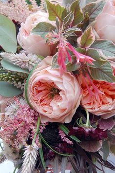 a bouquet of pink flowers and green leaves