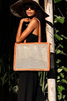 NOTE: Orders for the Careyes Tote will ship by December 10 via DHL Express and arrive no later than December 17. Free Domestic U.S. Shipping & Returns. This tote bag was handcrafted by an artisan in Bali, Indonesia, using locally sourced, renewable resources. Each piece is hand-finished with carefully chosen, sustainable materials. Dimensions: Strap length: 12" hanging Body Size: 16" (length) x 4" (width) x 14" (height) Handle: Leather / NaturalBasket: Organic Ata Grass / Natural with top zi Leather Basket, Tan Top, Rattan Bag, Leather Artisan, Go Bags, Resort Collection, Leather Pouch, Classic Collection, Sustainable Materials