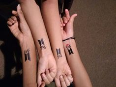 three people with matching tattoos on their arms