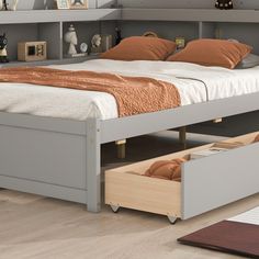 a bed with two drawers underneath it