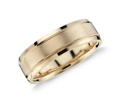 a yellow gold wedding ring with two lines on the inside and outside, set against a white background