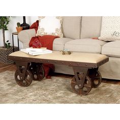 a coffee table with wheels on it in front of a couch