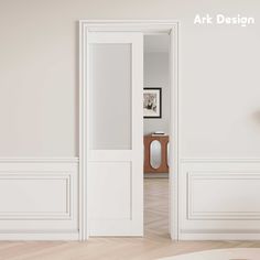 an empty room with white walls and wooden flooring is seen through the open door