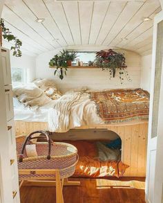 there is a bed in the room with plants on the wall and a basket next to it